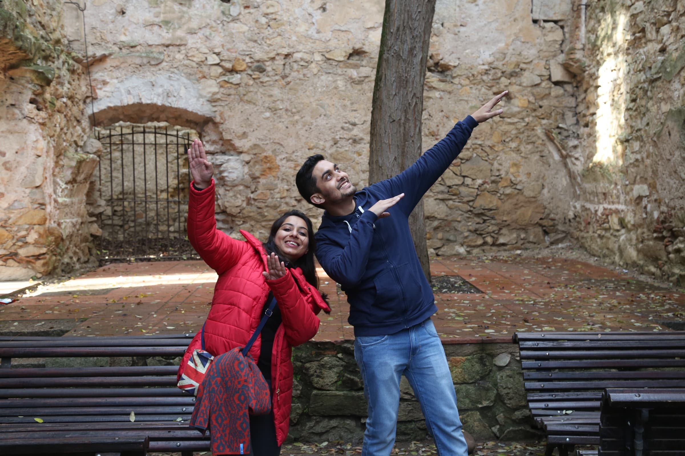 Palak and Pranav striking a pose among old stone walls